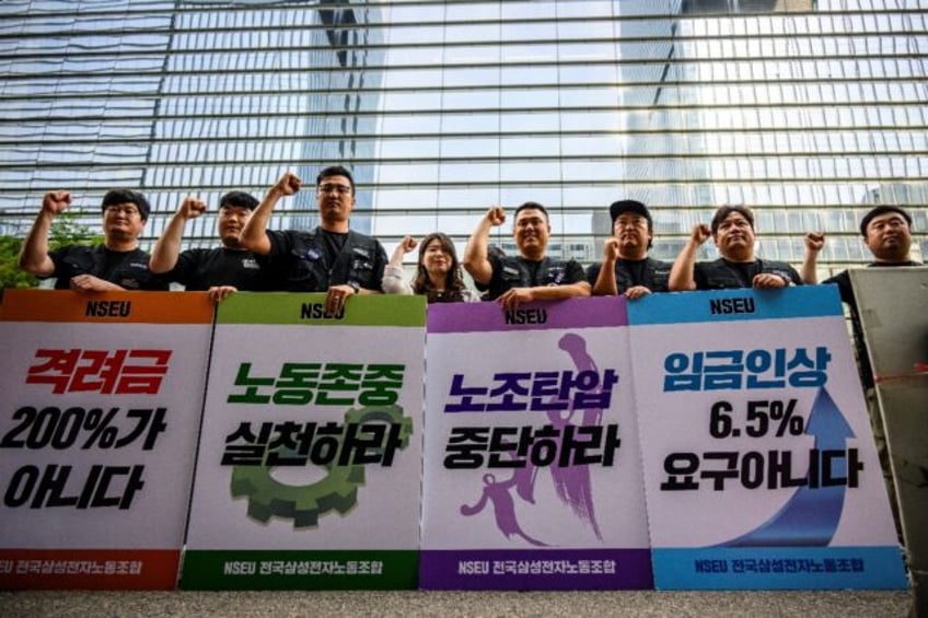 Samsung Electronics' union members hold placards during a rally outside the company buildi