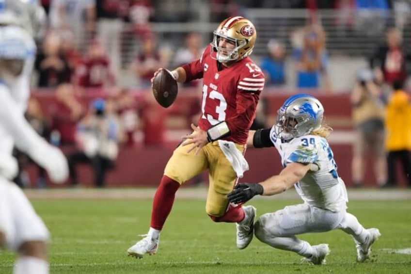 San Francisco 49ers quarterback Brock Purdy evades a tackler during his team's NFC Championship win over Detroit