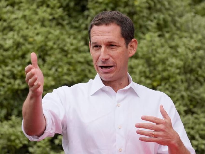 San Francisco mayoral candidate Daniel Lurie gestures while meeting with people at a neigh