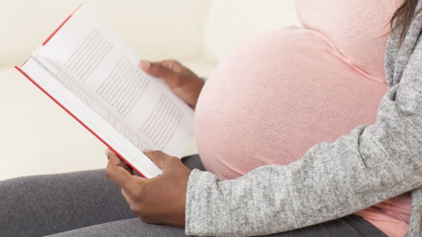 Pregnant woman reading book