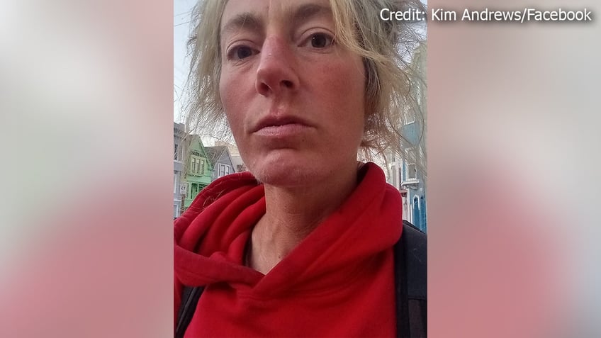 Kim Andrews is seen wearing a red hoodie in a selfie.