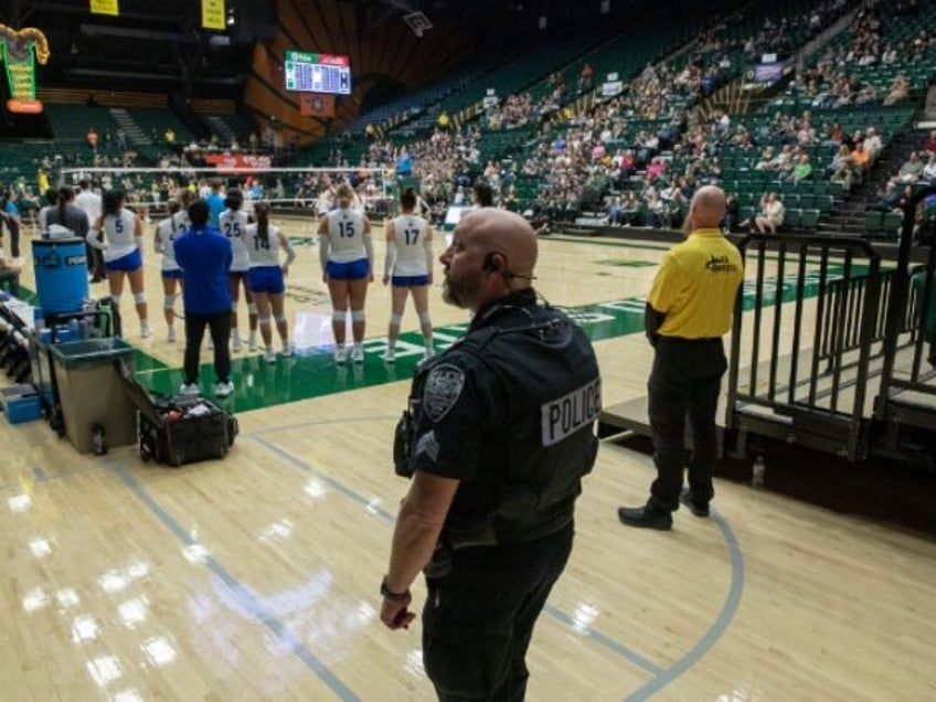 Colorado State University police behind the San Jose State University Spartans bench monit