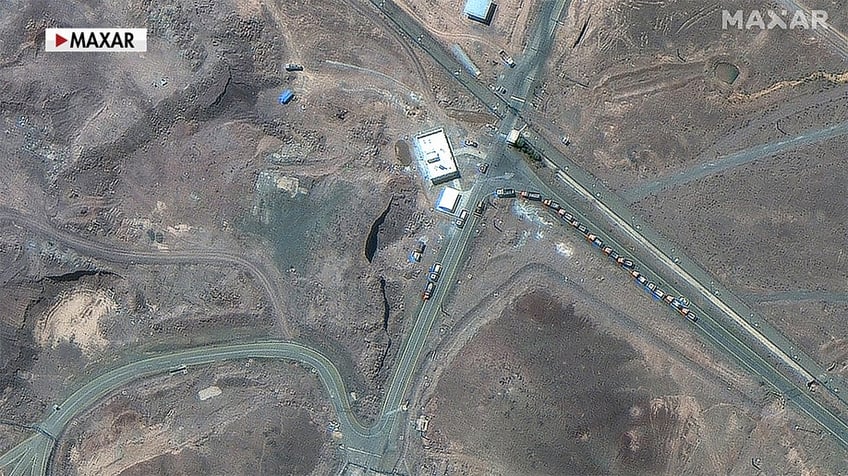 cargo trucks positioned near underground entrance of Fordow