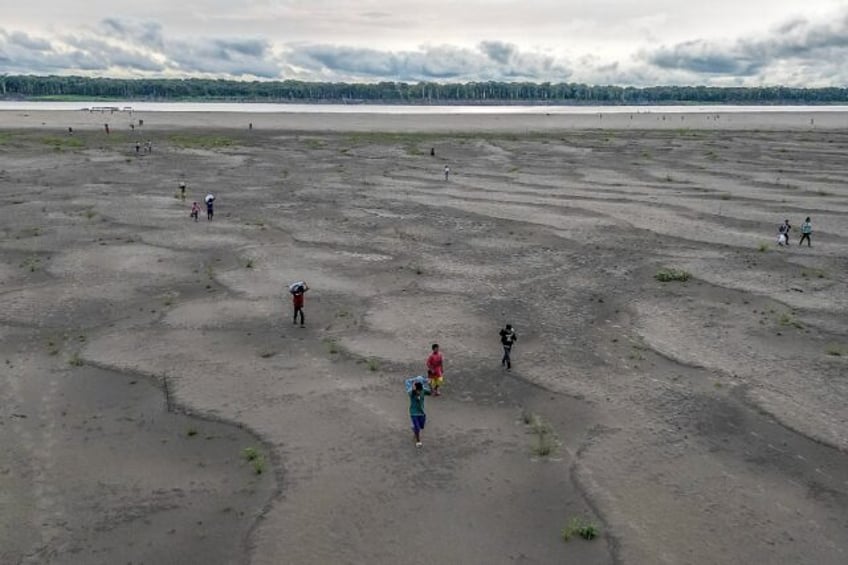 Inigenous Yagua people are forced to travel long distances to fetch water after drought in