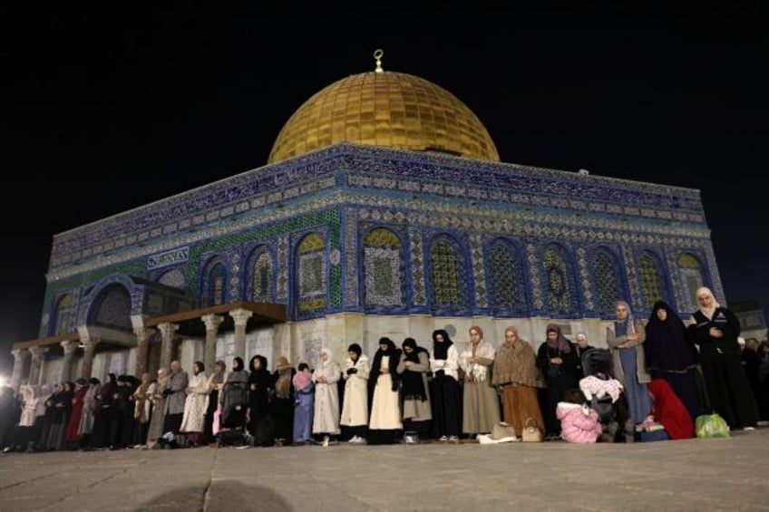 Palestinian Muslims hold eve-of-Ramadan prayers outside the Dome of the Rock in Israeli-an