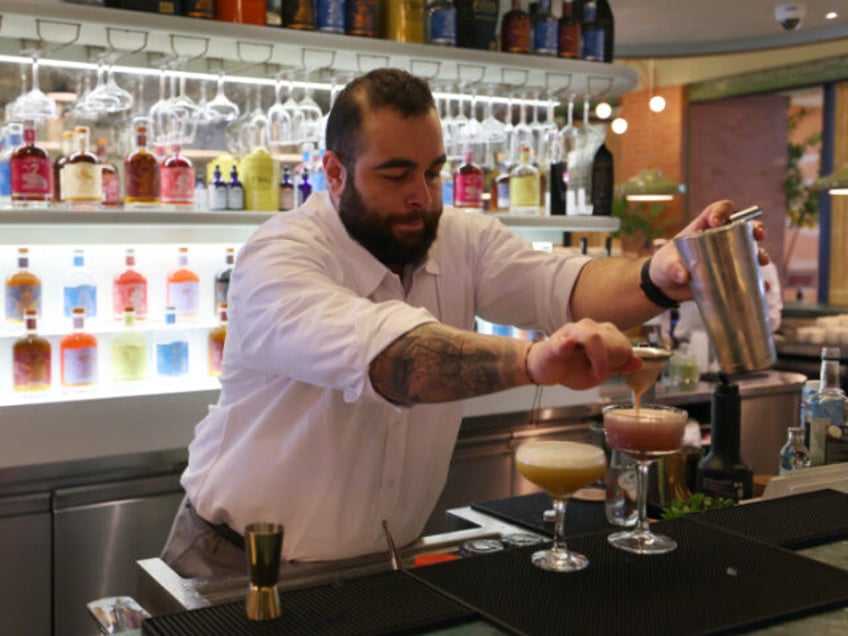 Lebanese bartender Hadi Ghassan prepares a drink behind the counter at "Meraki Riyadh", a pop-up bar offering non-alcoholic bellinis and spritzes, served in chilled cocktail glasses, in Riyadh on January 23, 2024. The bar's success highlights widening acceptance of more daring non-alcoholic fare even as booze itself remains strictly off-limits …