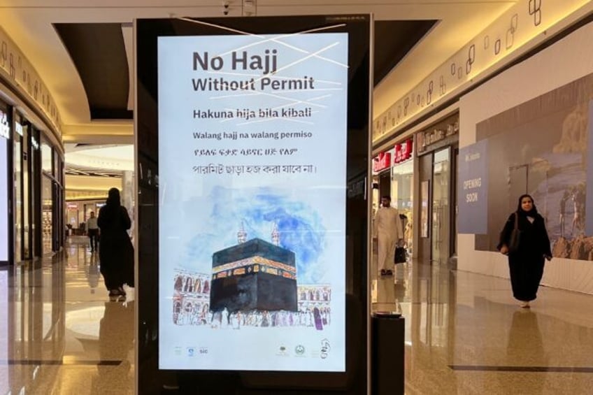 A billboard in a Riyadh shopping mall stresses that a permit is required to be able to per