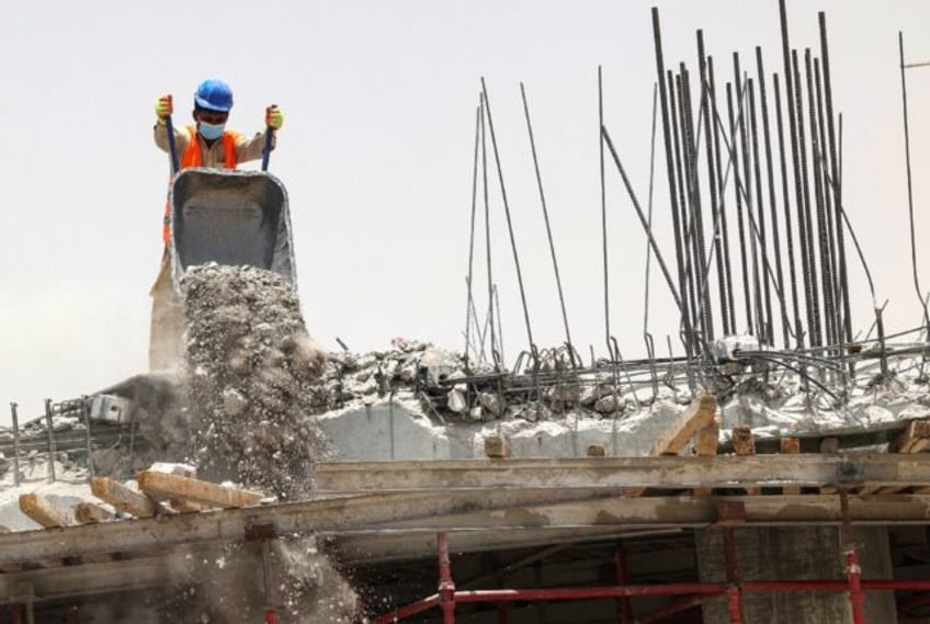 A foreign labourer works at a construction site in the scorching heat of Riyadh