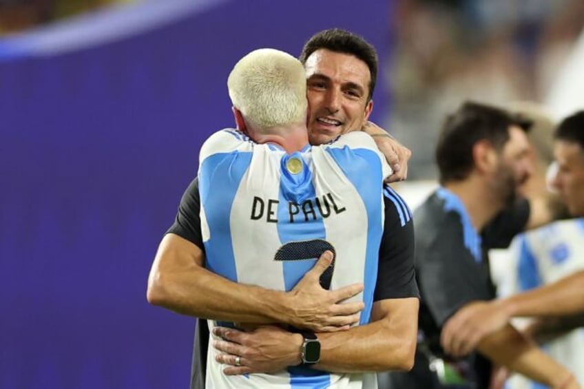 Argentina coach Lionel Scaloni embraces midfielder Rodrigo De Paul after Sunday's Copa Ame