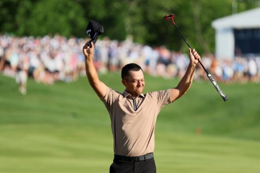 Third-ranked Xander Schauffele celebrates after sinking a six-foot birdie putt on the par-