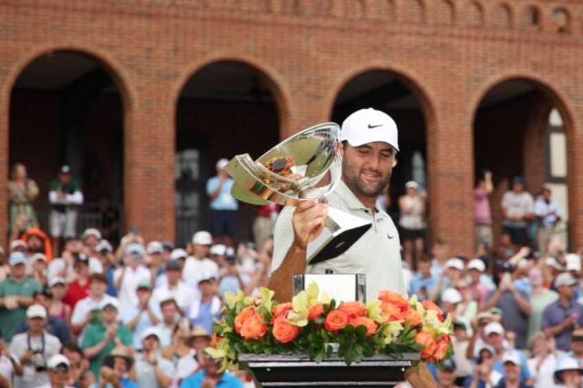 Scottie Scheffler celebrates with the FedEx Cup Trophy after his win at the Tour Champions