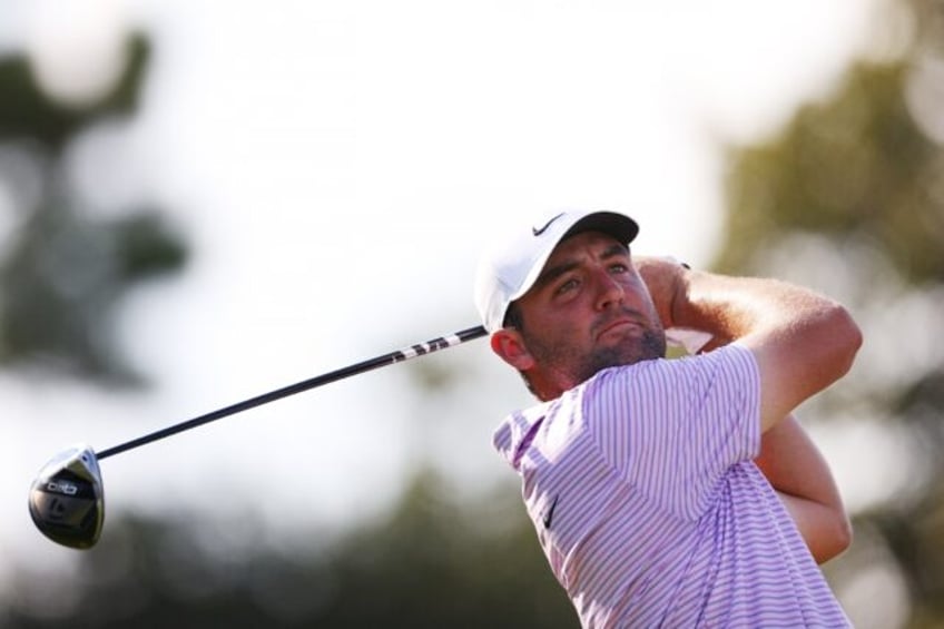 Leader Scottie Scheffler of the United States hits his shot from the 18th tee during the f