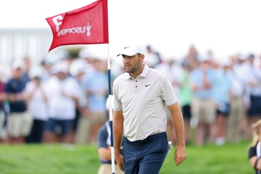 World number one Scottie Scheffler of the United States walks across the third green durin