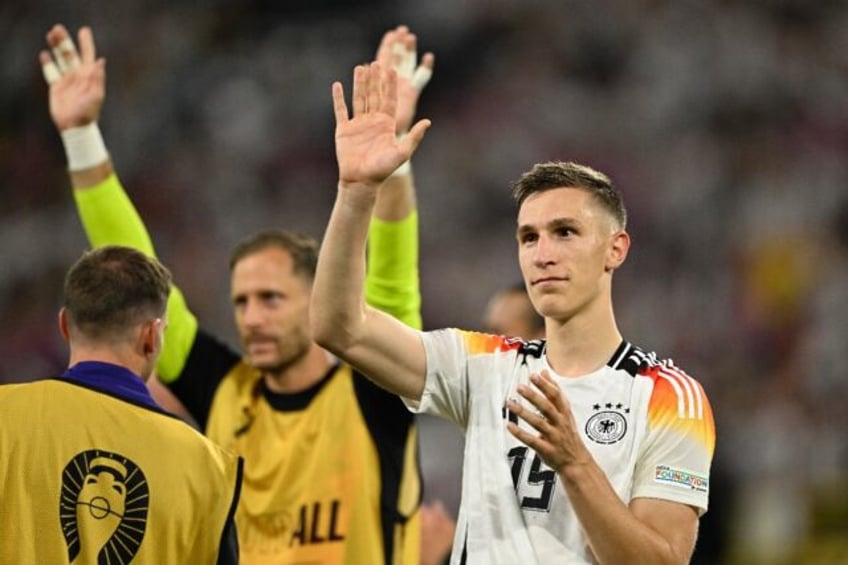 Nico Schlotterbeck waves to fans after Germany beat Denmark in Euro 2024