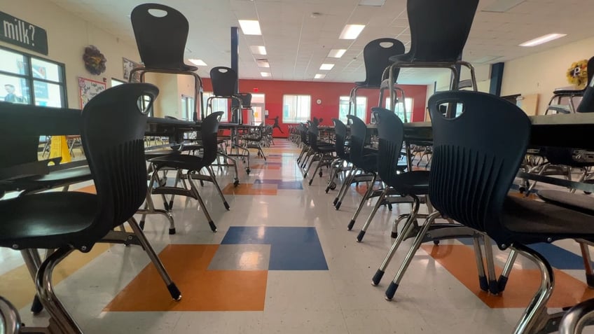 A school classroom with desks and chairs