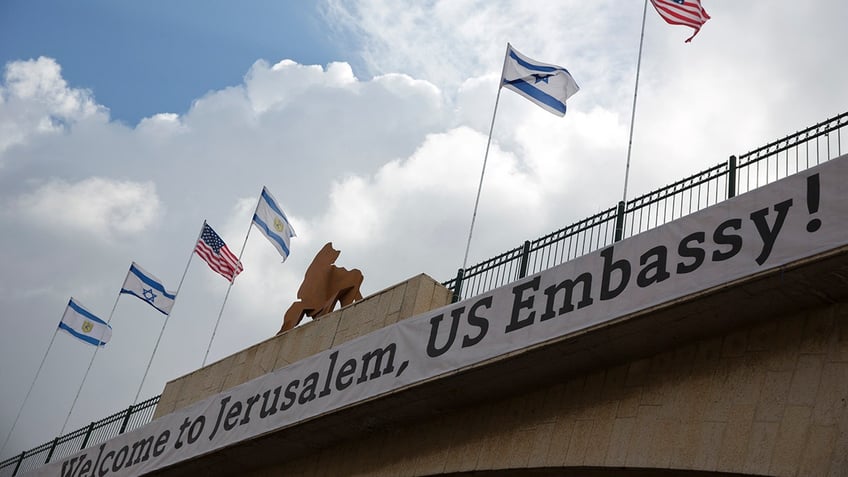 A sign on a bridge leading to the US Embassy compound ahead the official opening in Jerusalem, Sunday, May 13, 2018. Monday's opening of the U.S. Embassy in contested Jerusalem, cheered by Israelis as a historic validation, is seen by Palestinians as an in-your-face affirmation of pro-Israel bias by President Donald Trump and a new blow to frail statehood dreams. (AP Photo/Ariel Schalit)