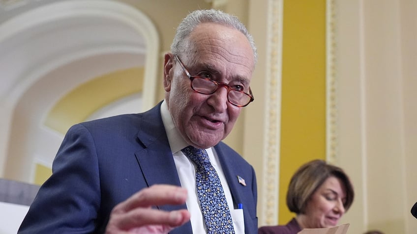 Senate Minority Leader Chuck Schumer, D-N.Y., joined by Sen. Amy Klobuchar, D-Minn., right, speak to reporters following closed-door party meetings at the Capitol in Washington, Tuesday, June 17, 2025. 