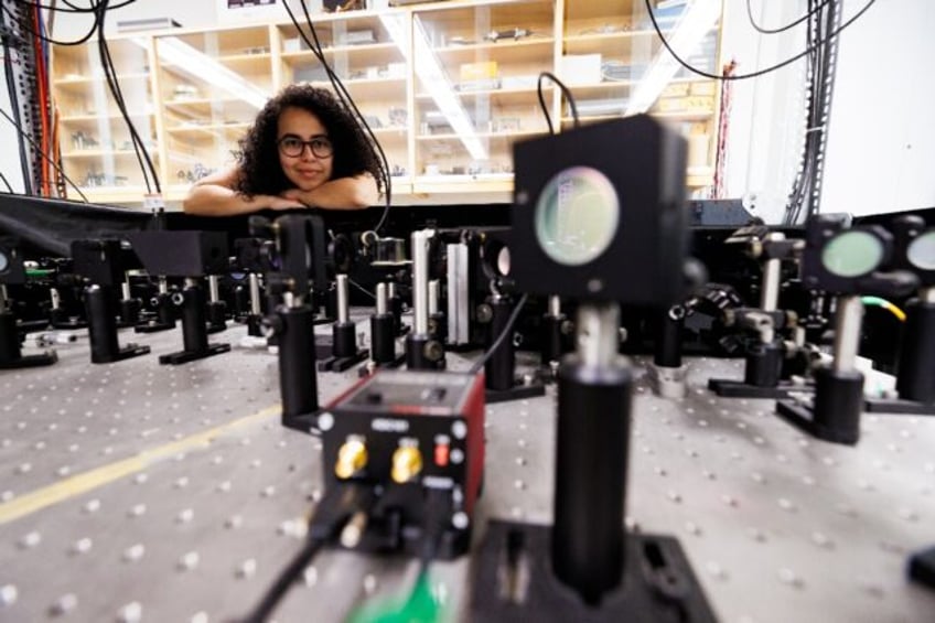 Experimental physicist Daniela Angulo poses with an apparatus in the physics lab at the Un