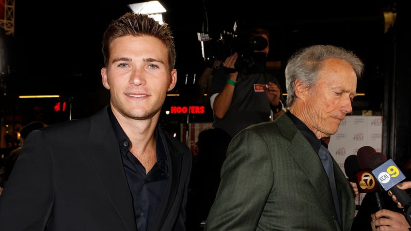 Director Clint Eastwood (R) is interviewed with his son Scott Eastwood at his side, at the opening night gala for AFI Fest 2011 with the premiere of Eastwood's film "J. Edgar" in Hollywood November 3, 2011. REUTERS/Fred Prouser (UNITED STATES - Tags: ENTERTAINMENT) - RTR2TLFU