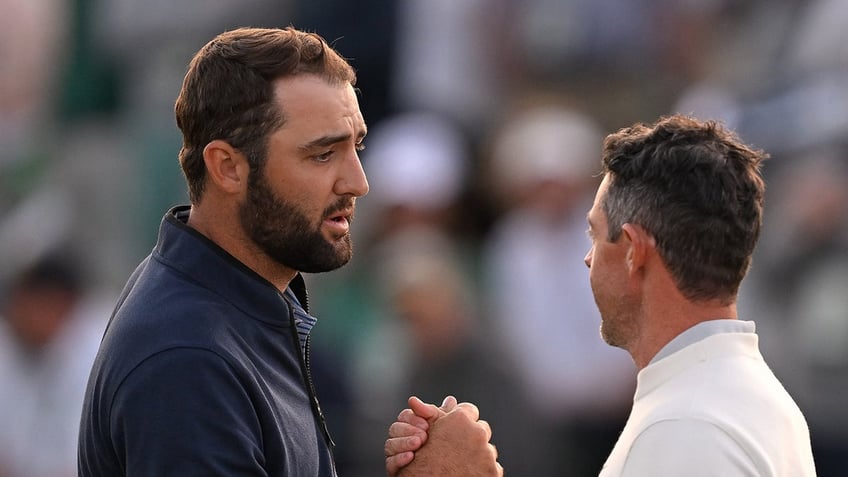 Scottie Scheffler shakes hands with Rory McIlroy 