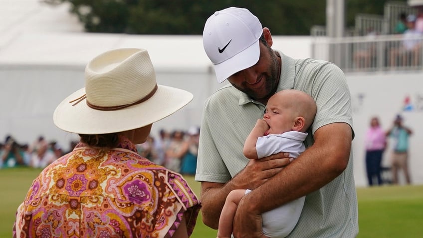 Scottie Scheffler holds his son, Bennett