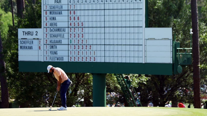 Scottie Scheffler in front of the leaderboard