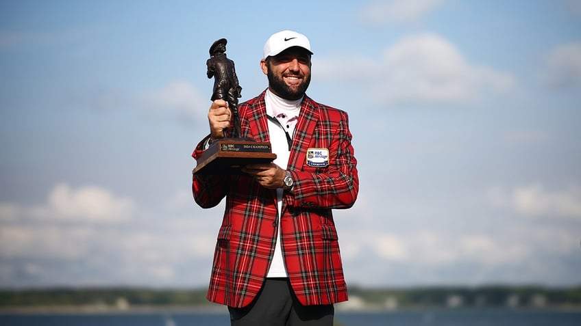 Scottie Scheffler holds trophy