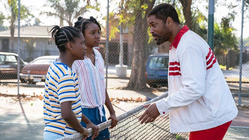 Will Smith, right, with Demi Singleton, left, and Saniyya Sidney in a scene from "King Richard." 
