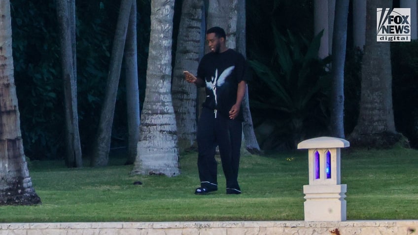 Sean "Diddy" Combs walks outside of his Star Island home in Miami Beach, Florida