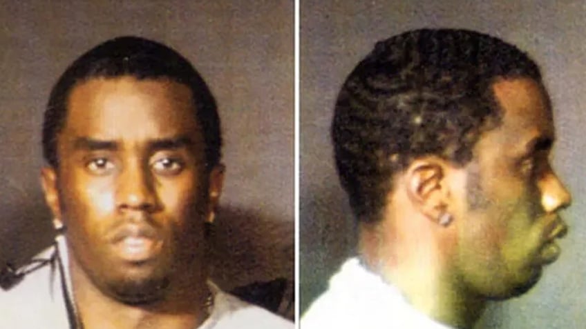 Sean Diddy Combs poses for mugshot 1999