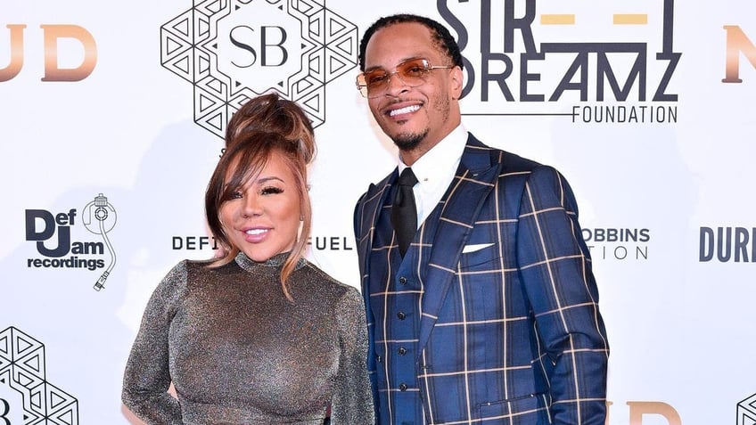 Tameka "Tiny" Harris and T.I. on a red carpet outside an Atlanta gala