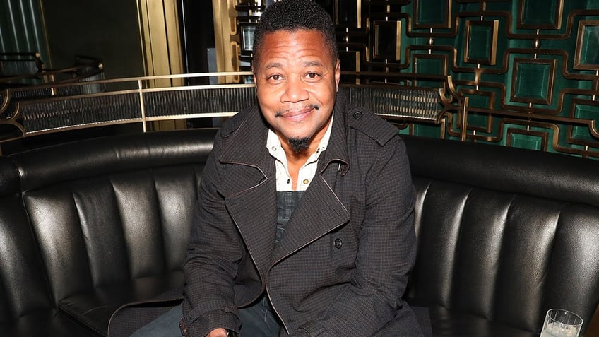 Cuba Gooding Jr. wears black trench coat