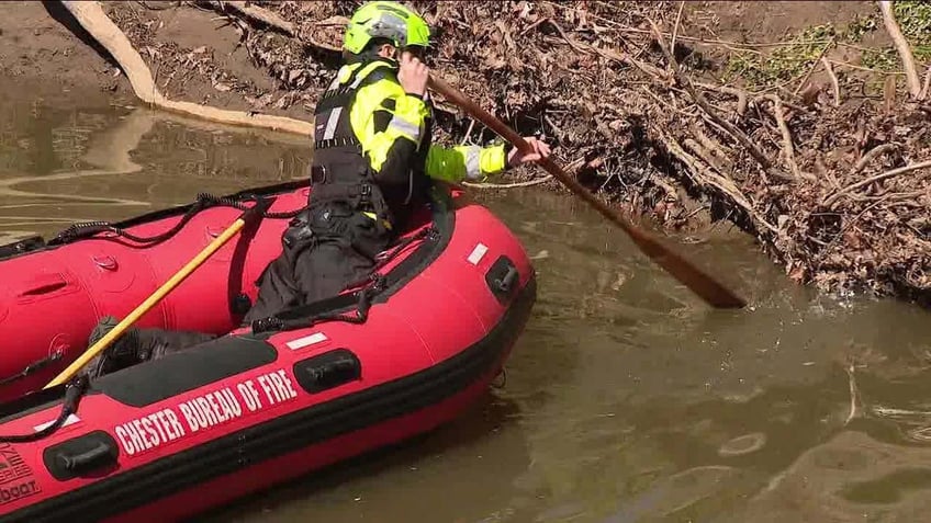 rescuers searching in creek
