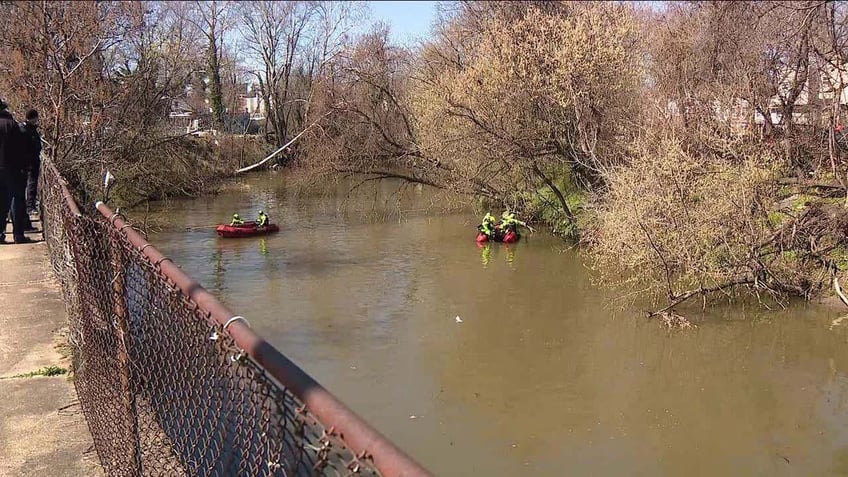 rescuers searching in creek