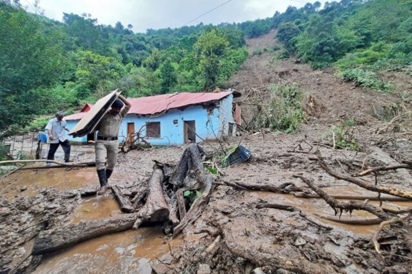 search for survivors after indian floods landslides kill 65