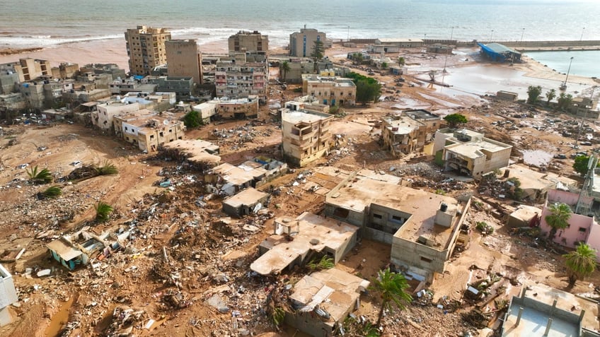 searchers race to recover bodies in libya as death toll from flooding hits 5100