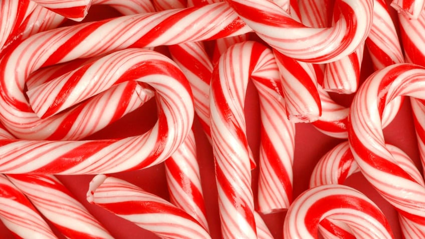 Candy canes are shown up close on top of each other.