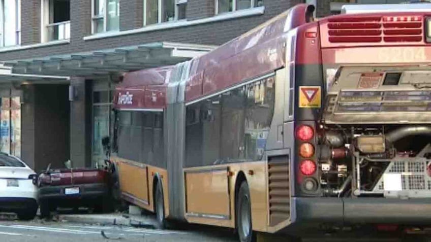 seattle bus crashes into building killing pedestrian and injuring 12