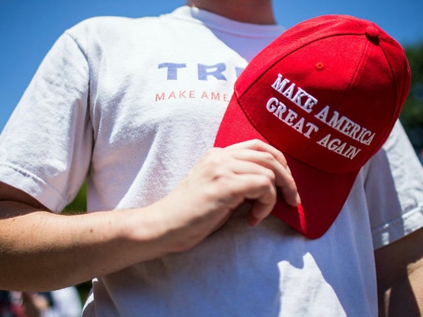 WASHINGTON, DC - JULY 05: A supporter of U.S. President Donald Trump holds a Make America