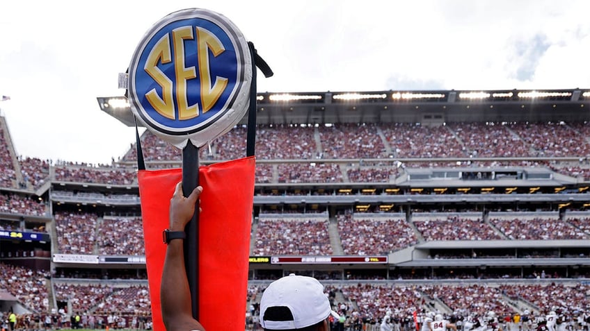 The SEC logo on a yard marker