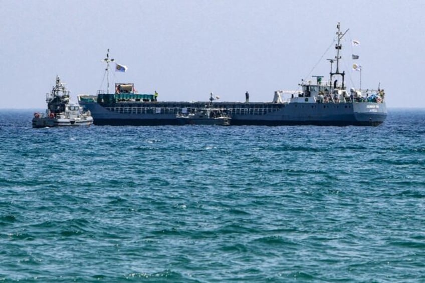 A Cyprus coastguard vessel approaches the aid ship Jennifer off Larnaca ahead of its depar