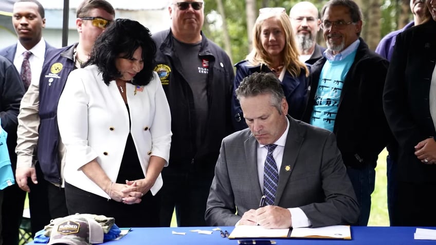 second amendment advocates celebrate alaska gov dunleavy signing gun store law a protective shield