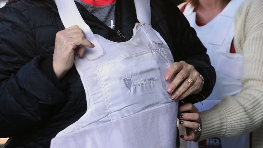 a woman tried on a body armor vest