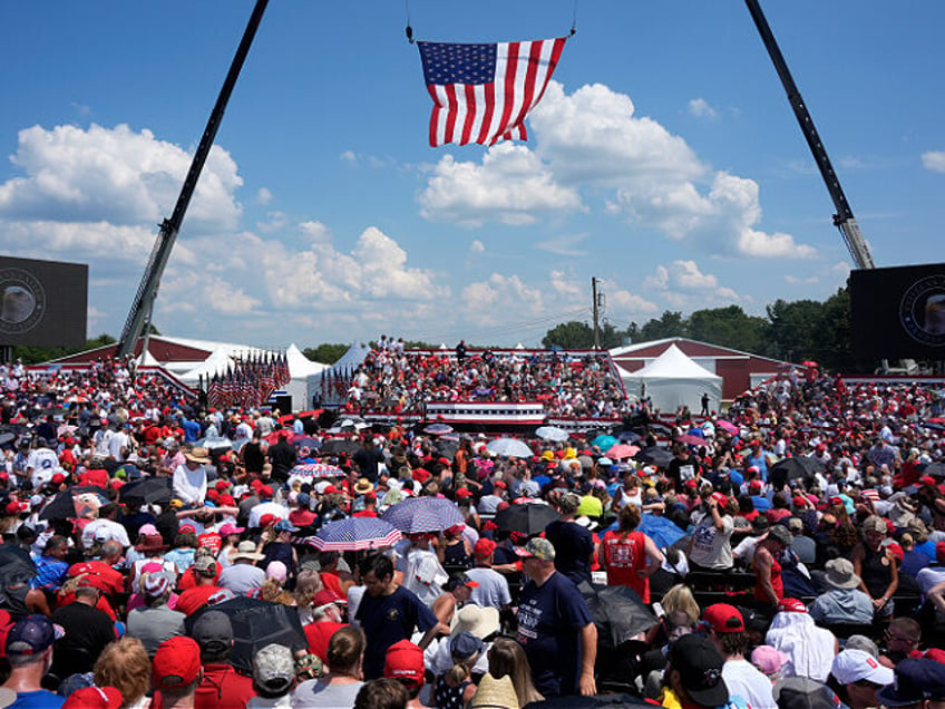 A crowd waits for Republican presidential candidate former President Donald Trump to speak