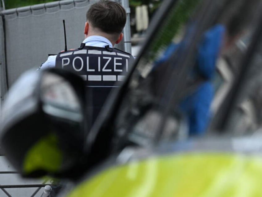 A police officer works at the scene after several people were injured in a knife attack on