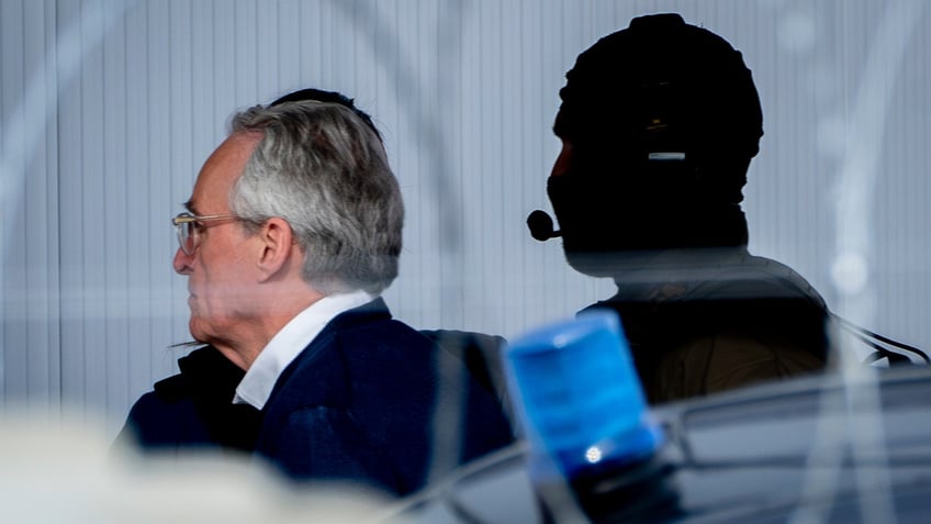 The main defendant Heinrich XIII Prinz Reuss is escorted into the court room.