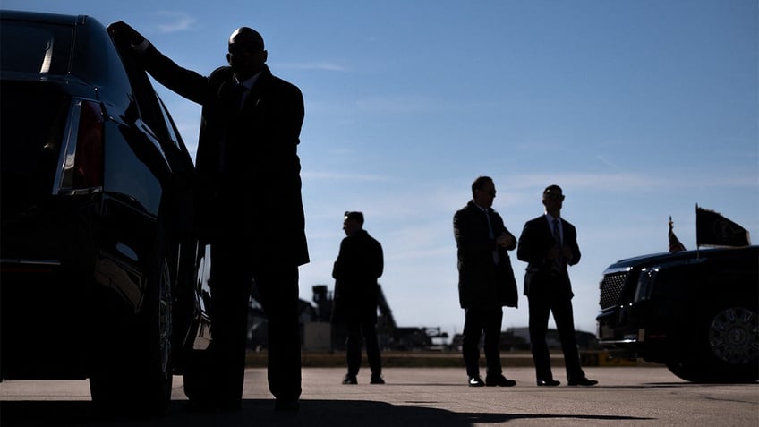 Secret Service members helping the president