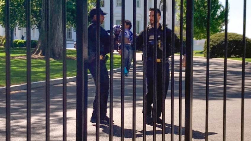 U.S. Secret Service uniformed division police officers carry a young child