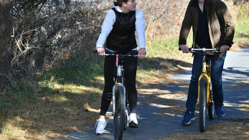 Naomi Biden and then-fiance on bikes during Thanksgiving vacation to Nantucket in 2021