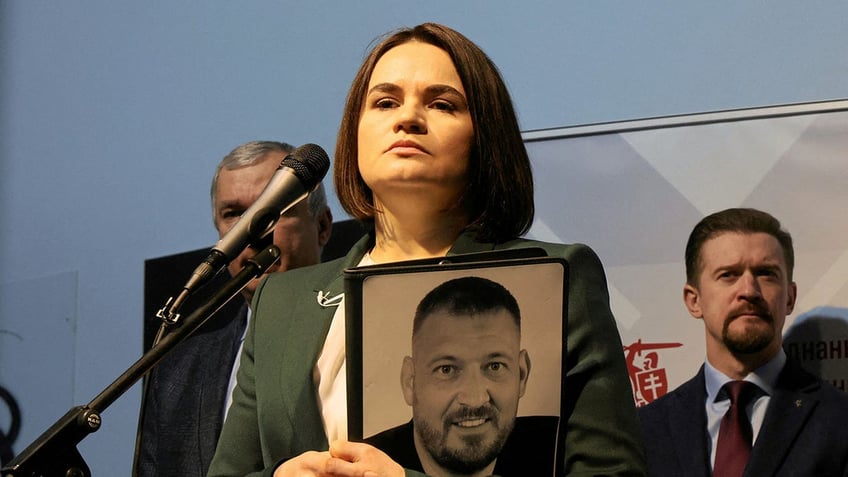 Sviatlana Tsikhanouskaya holds photo of jailed husband